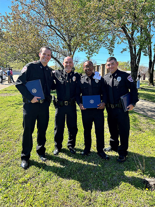 ɫƵ Assistant Police Chief Brian Locke, second from left, recently congratulated ɫƵPD officers Tyler Hawkins, left, Deveair Salter, and William Bowling on their graduation from the North Mississippi Law Enforcement Training Academy